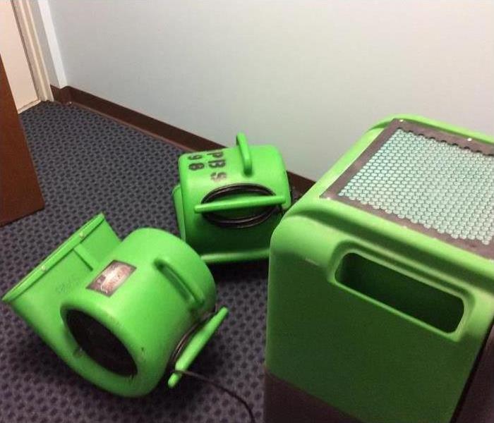 Photo of 2 air movers and 1 dehumidifier strategically place in a commercial building