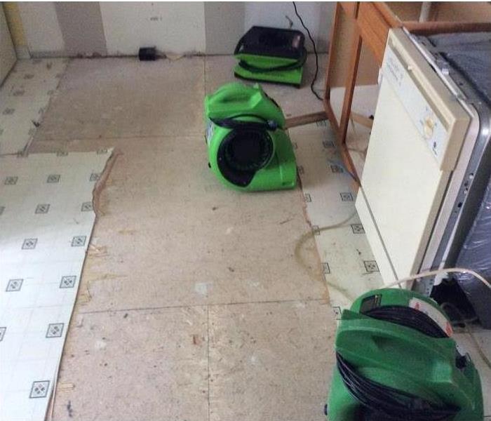 picture of green air movers drying a kitchen