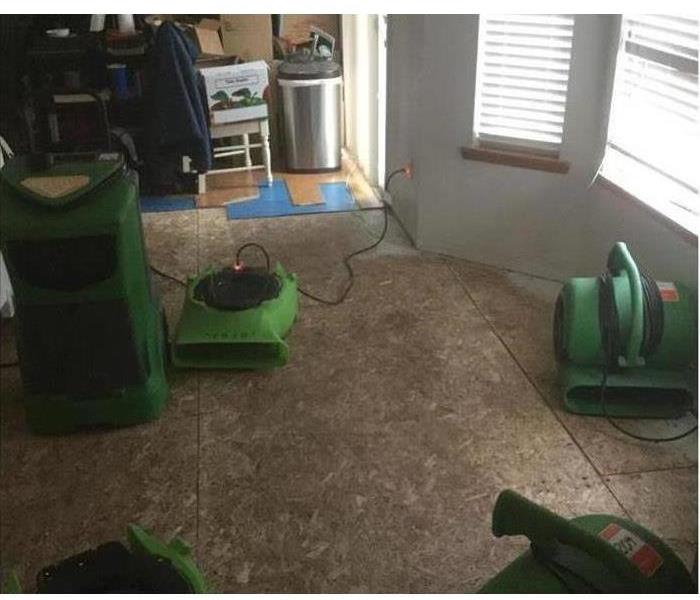 green air movers drying a kitchen and dining room 